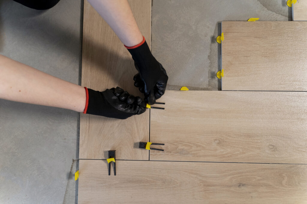 flat lay worker tiling floor